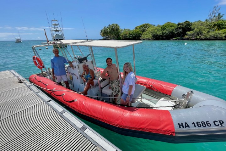a group of people in a boat on a body of water