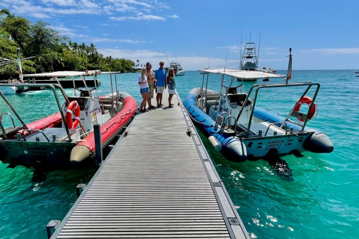 a boat that is sitting on a dock next to a body of water